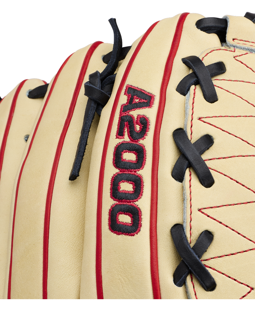 Close-up of the Wilson A2000 DH12 12″ Baseball Glove: WBG06101RT12, crafted from Pro Stock leather in tan with red stitching and black laces. The text “A2000” is embroidered in red and black on the glove, which features a distinctive Dual Hinge Web for added performance.