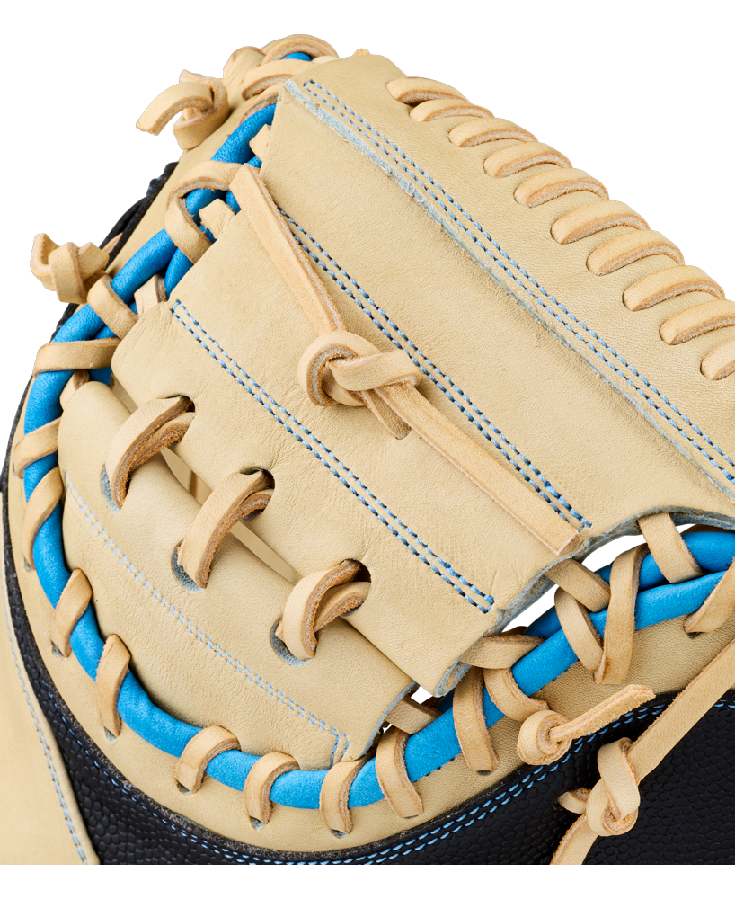 Close-up of the Wilson A2000 M23SS 33.5″ Baseball Catcher’s Mitt (WBG06201RT335) in tan leather, featuring tan laces and blue stitching details that highlight the intricate lacing and craftsmanship on the webbing and edge—perfect for precise pitch-framing behind the plate.