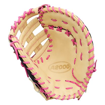 Wilson A2000 1673SS 13″ Baseball First Base Mitt (WBG06301RT13) by Wilson, featuring a tan design with pink lacing and the iconic Wilson A2000 logo on the palm—shown open to highlight its interior and webbing, delivering standout style for first basemen.