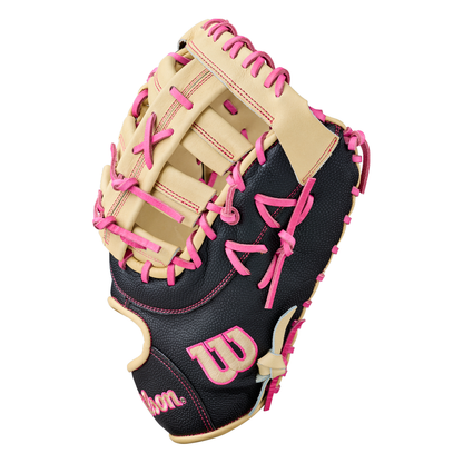 A Wilson A2000 1673SS 13″ Baseball First Base Mitt (WBG06301RT13) by Wilson, featuring a black and tan design with pink laces and accents, is displayed against a white background.