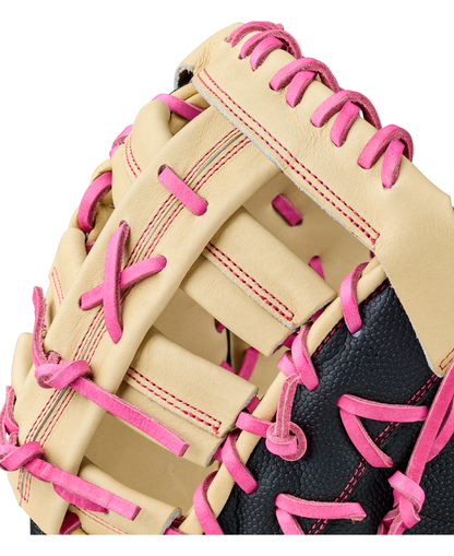 Close-up of the Wilson A2000 1673SS 13″ Baseball First Base Mitt (WBG06301RT13), featuring beige and black leather with bright pink laces and stitching, highlighting its detailed texture and expert craftsmanship.