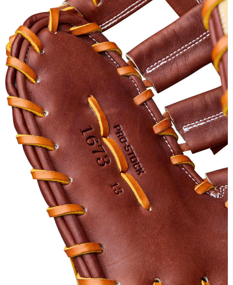Close-up of the Wilson A2000 1673 13″ Baseball First Base Mitt, crafted from Pro Stock leather with yellow laces, visible stitching, and “1673” and “PRO STOCK” embossed on the inner palm—perfect for any first baseman.