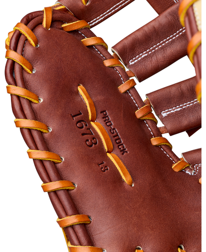 Close-up of the Wilson A2000 1673 13″ Baseball First Base Mitt, crafted from Pro Stock leather with yellow laces, visible stitching, and “1673” and “PRO STOCK” embossed on the inner palm—perfect for any first baseman.
