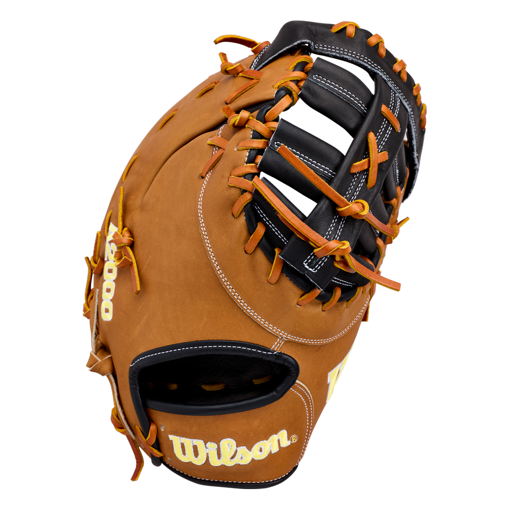 A close-up of the Wilson A2000 1677 12.5″ Baseball First Base Mitt (WBG06501RT125), crafted from rich brown Pro Stock leather with black webbing and striking orange laces, features the Wilson brand name stitched in yellow on the wrist area.