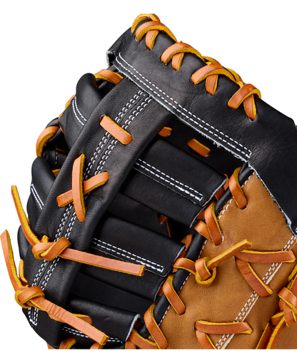 Close-up of the Wilson A2000 1677 12.5″ Baseball First Base Mitt (WBG06501RT125) by Wilson, highlighting its black and brown Pro Stock leather construction, orange laces, and white stitching to showcase its detailed texture and expert craftsmanship.