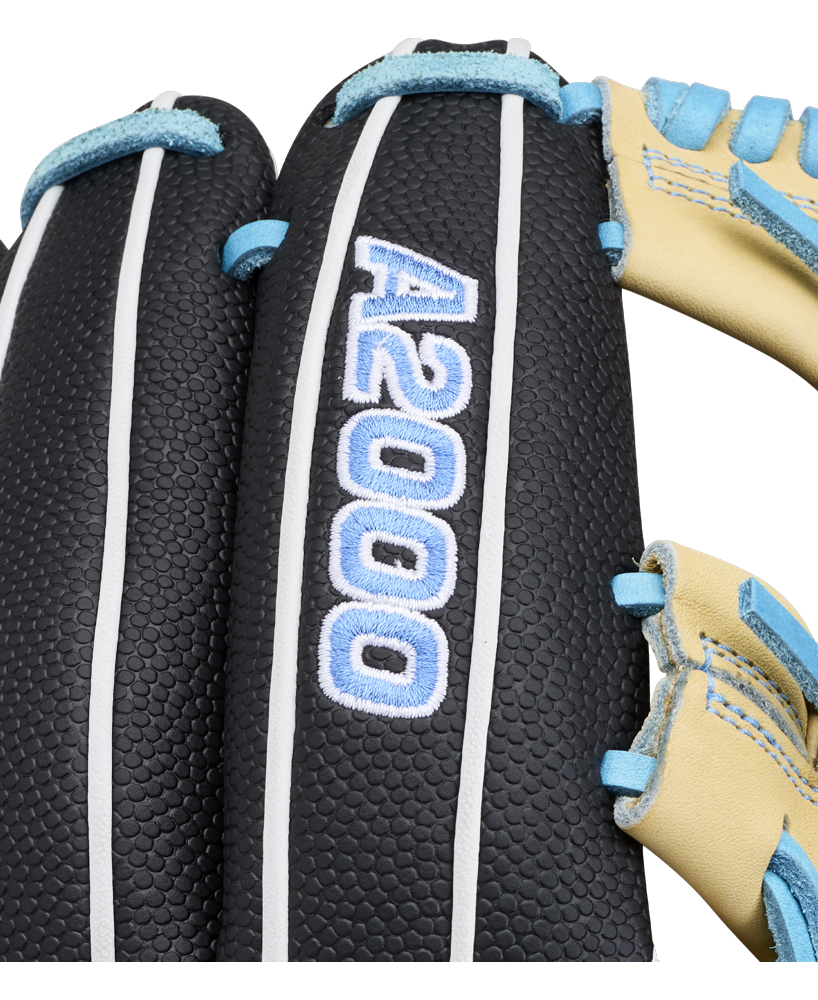 Close-up of the Wilson A2000 FP1175SS 11.75″ Fastpitch Glove, featuring black leather with white edging, blue stitching, and the model name “A2000 FP1175SS” embroidered in blue and white letters. The glove also displays part of its tan leather webbing.