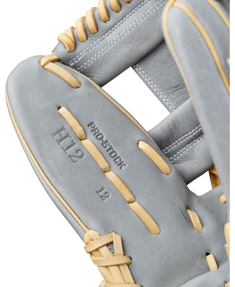 Close-up of a gray leather Wilson A2000 H12 12″ Fastpitch Glove (WBG06801RT12) with tan laces. Text on the glove reads H12, PRO STOCK, and 12” infield glove.