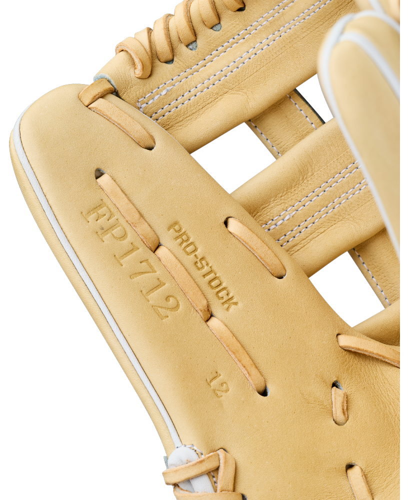 Close-up of the Wilson A2000 FP1712 12″ Fastpitch Glove (WBG06901RT12) in tan, featuring embossed text—FP1712, PRO STOCK, and 12—on the leather palm, with visible stitching and lacing details that highlight Wilson’s Flex System for added comfort and performance.