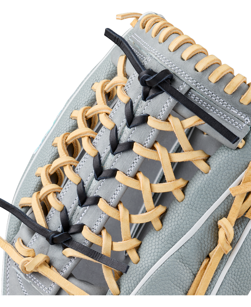 Close-up of the Wilson A2000 T125SS 12.5″ Fastpitch Glove, featuring grey leather with tan laces and black accents by Wilson, showcasing the detailed lacing pattern and textured surface of the glove.