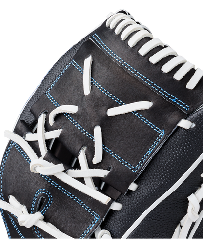 Close-up of the Wilson A2000 FPB25SS 12.25″ Fastpitch Glove (WBG07201RT1225), featuring black leather with white laces and blue stitching, highlights the detailed craftsmanship and textured finish. This expertly designed 12.25” pitcher’s glove from Wilson offers fastpitch players outstanding performance and style.