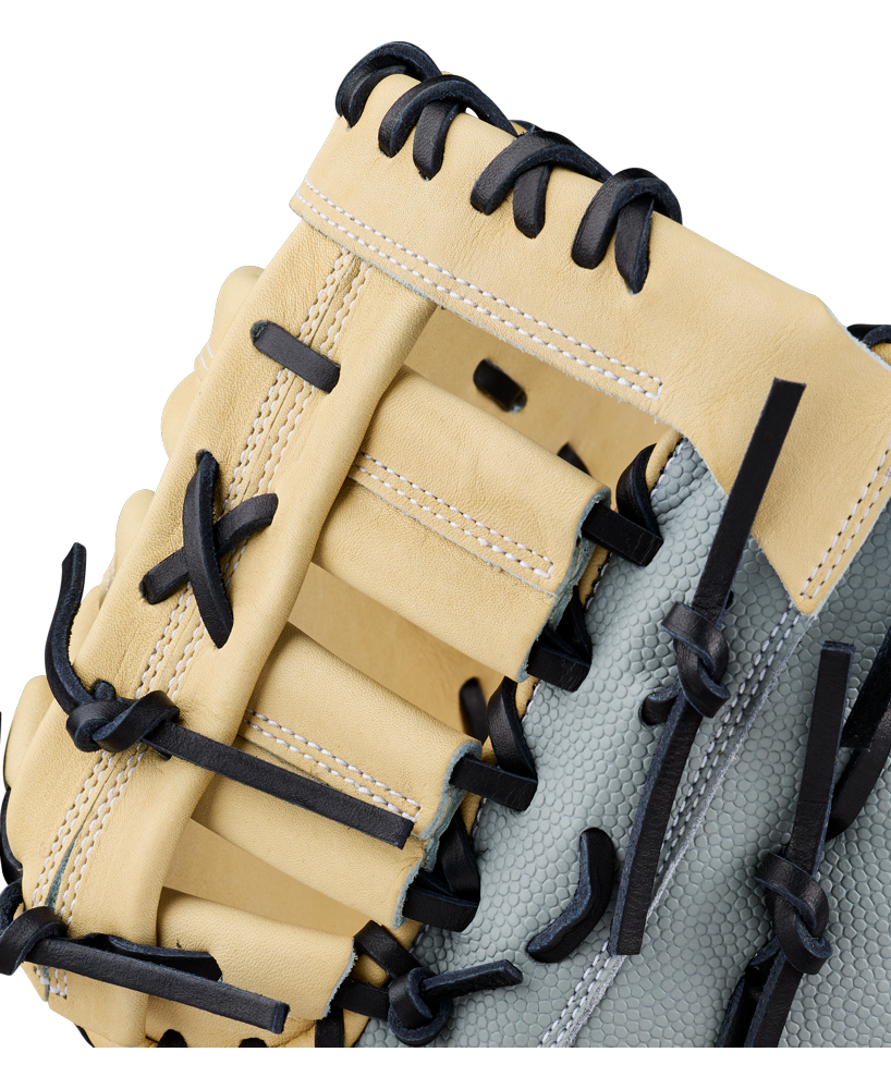 Close-up of a beige and gray Wilson A2000 FP1620SS 12.5″ Fastpitch First Base Mitt featuring black laces and detailed stitching, highlighting the texture and craftsmanship of this Wilson glove.