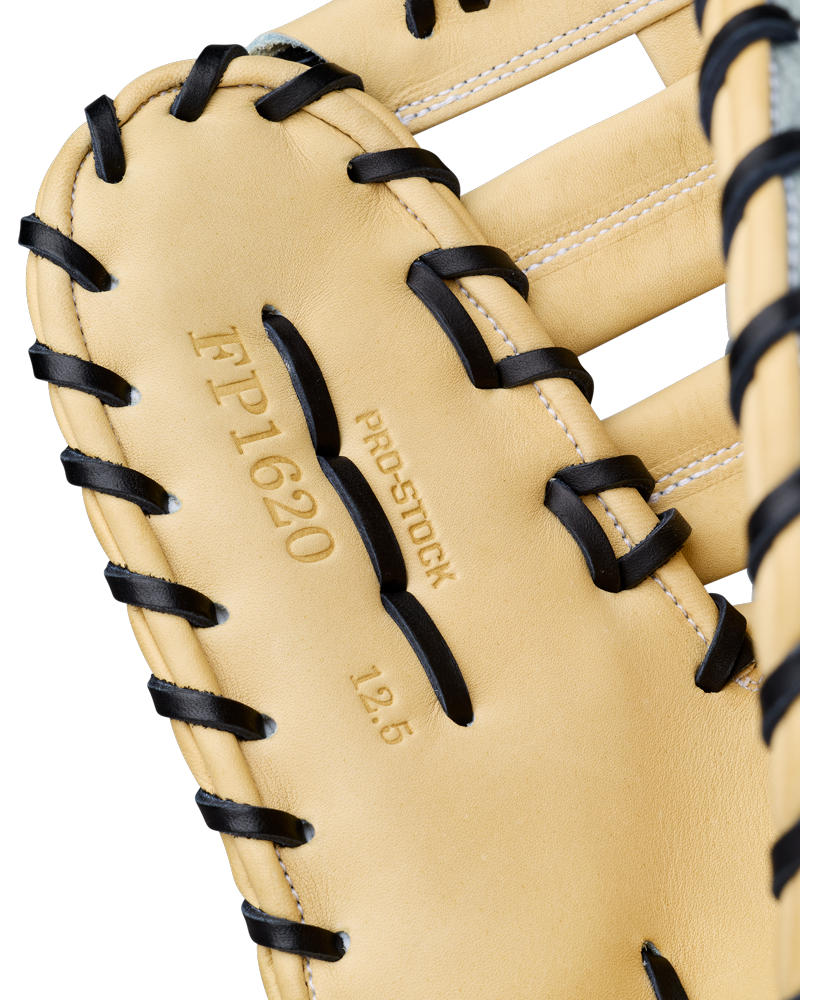 Here’s a revised version of your sentence, incorporating the provided product data: Close-up of a tan 12.5” Wilson A2000 FP1620SS Fastpitch First Base Mitt, expertly crafted from Pro Stock leather with contrasting black laces. The glove displays the markings “FP1620,” “PRO STOCK,” and “12.5” to signify its model and size, with white stitching accentuating the leather sections throughout this Wilson mitt.