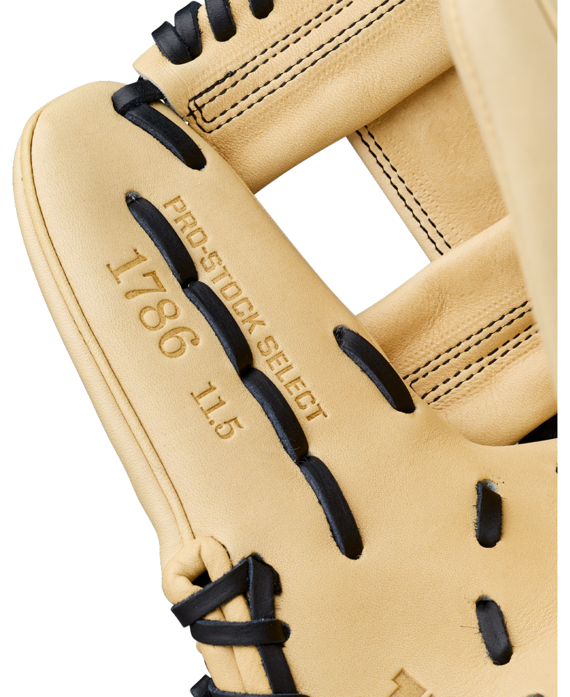 A close-up of a tan Wilson A2K 1786 11.5″ Baseball Glove (WBG07601RT115) with black laces, displaying the PRO STOCK SELECT 1786 11.5 stamp on the leather near the thumb area.