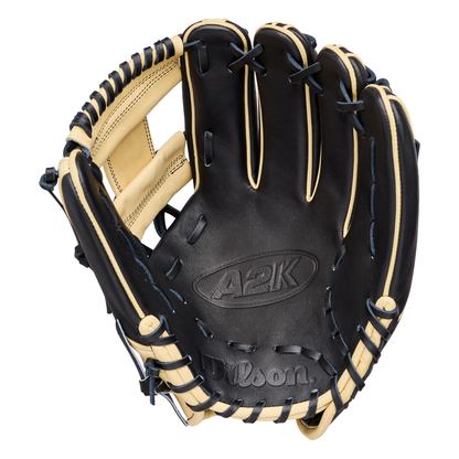 The Wilson A2K 1724 11.75″ Baseball Glove (WBG07701RT1175) by Wilson is pictured open on a plain white background, showcasing its black and tan colorway, visible stitching, Double Palm Construction, and detailed lacing—making it an ideal infielder’s glove for serious players.