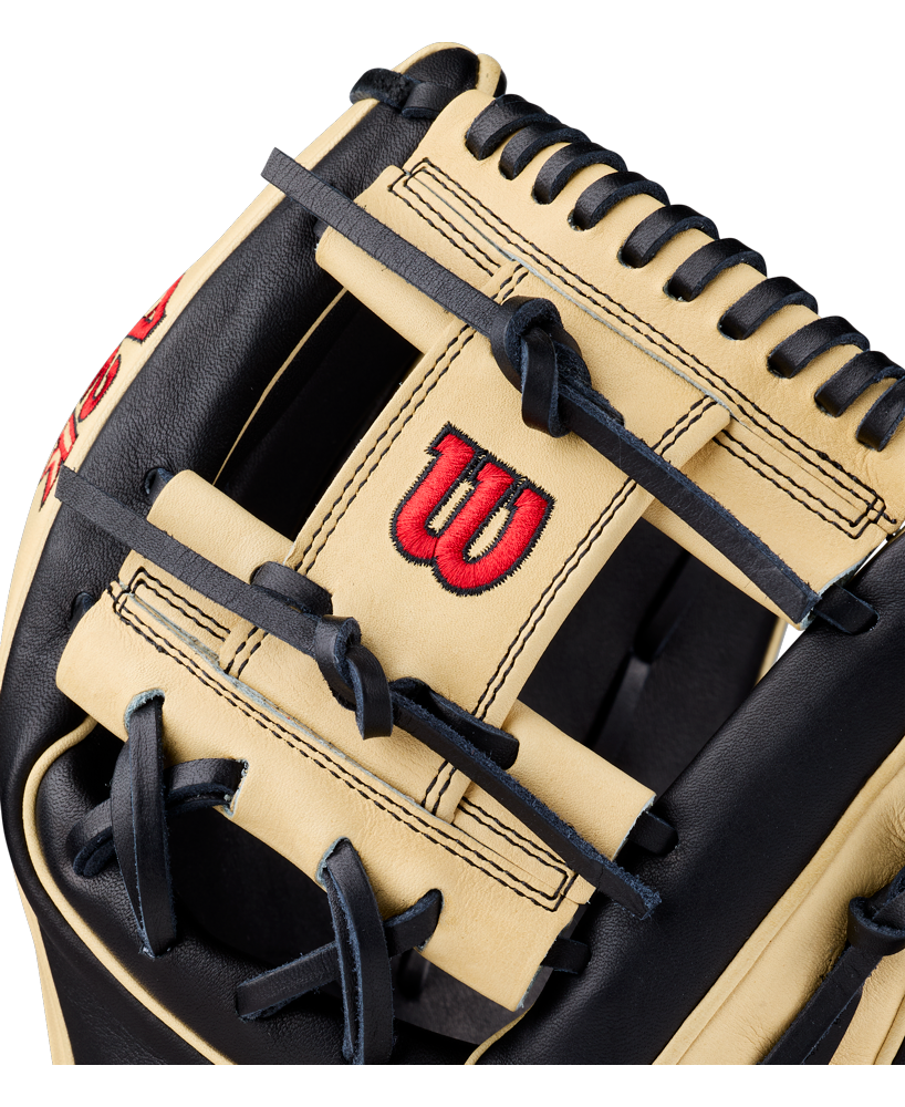 A close-up of the Wilson A2K 1724 11.75″ Baseball Glove (WBG07701RT1175) highlights its tan and black design, black laces, intricate stitching, Double Palm Construction, and a red Wilson “W” logo on the pocket.