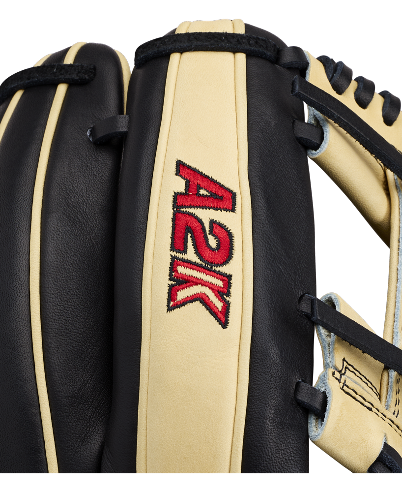 Close-up of a black and beige Wilson A2K 1724 11.75″ Baseball Glove (WBG07701RT1175), featuring the red and yellow Wilson A2K logo embroidered on the leather and showcasing its signature Double Palm Construction for added support.