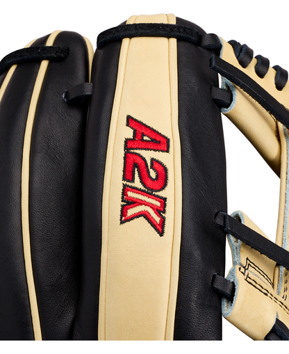 Close-up of a black and beige Wilson A2K 1724 11.75″ Baseball Glove (WBG07701RT1175), featuring the red and yellow Wilson A2K logo embroidered on the leather and showcasing its signature Double Palm Construction for added support.