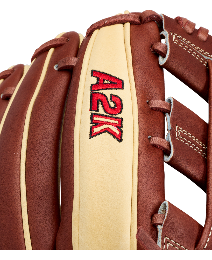 Close-up of the Wilson A2K DW5 12″ Baseball Glove by Wilson, showcasing brown and tan Pro Stock Select leather with “A2K” embroidered in red and black on the tan portion. The glove is detailed with white stitching along the brown leather lacing for enhanced durability.