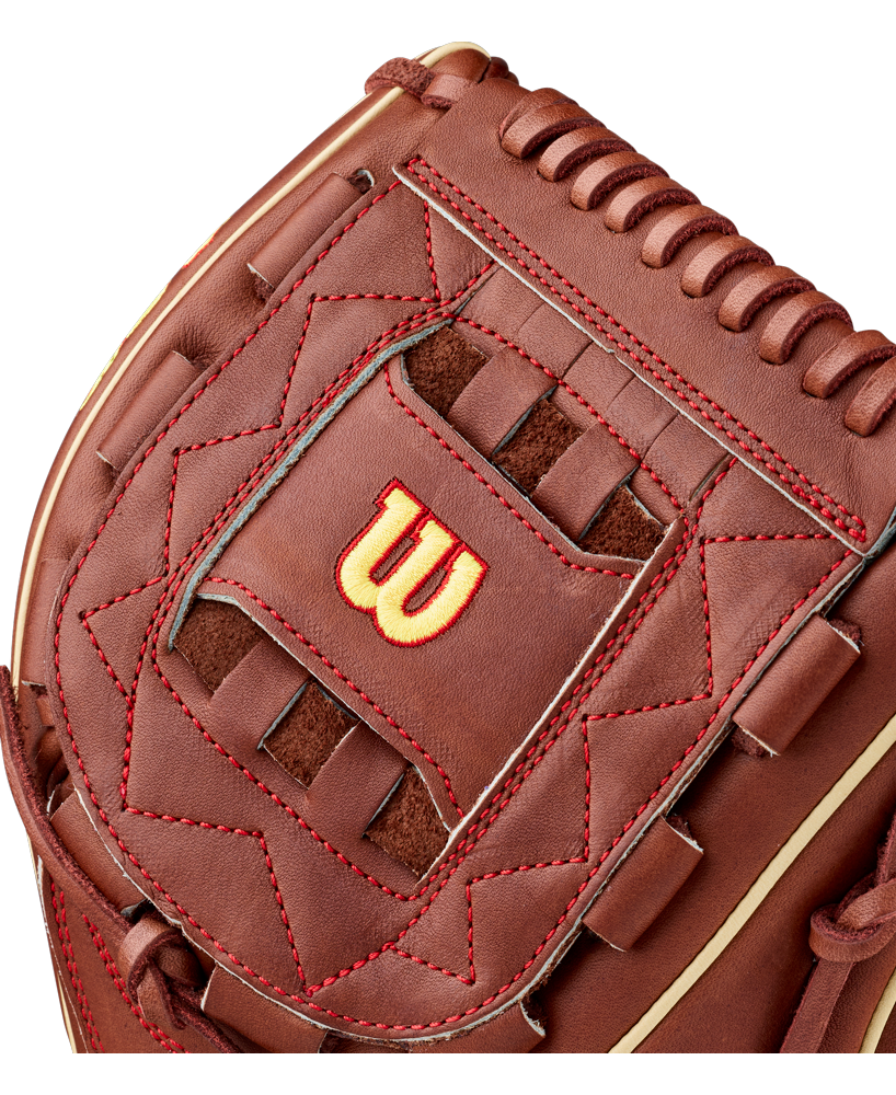 Close-up of a brown Wilson A2K C12 12″ Baseball Glove (WBG07901RT12) featuring red stitching, a yellow-outlined red Wilson “W” logo in the center, detailed lacing, a textured leather surface, and a deep pocket designed for optimal ball control.