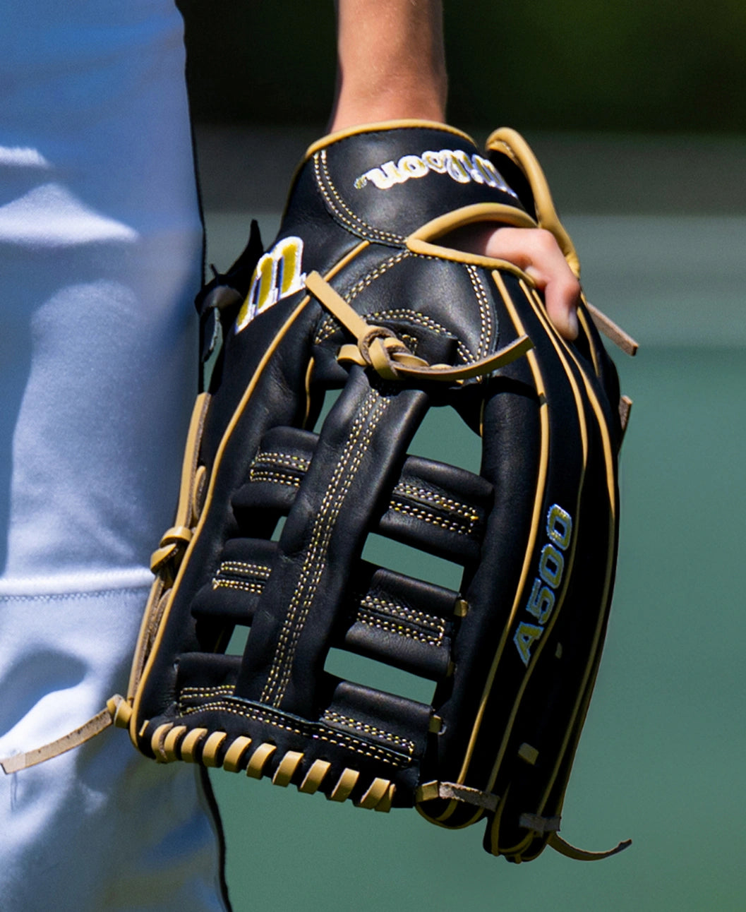 Wilson A500 12.5″ Baseball Glove: WBG08801RT125, a youth outfield glove in black with tan lacing and trim.