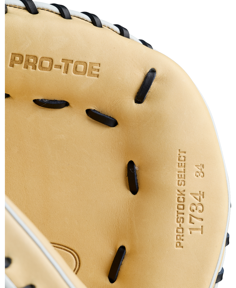 Close-up of a tan Wilson A2K 1734 34″ Baseball Catcher’s Mitt (WBG10701RT34) with black laces. The glove features the embossed markings PRO-TOE and PRO-STOCK SELECT 1734 34 near the webbing, showcasing its Double Palm Construction for enhanced durability and support.