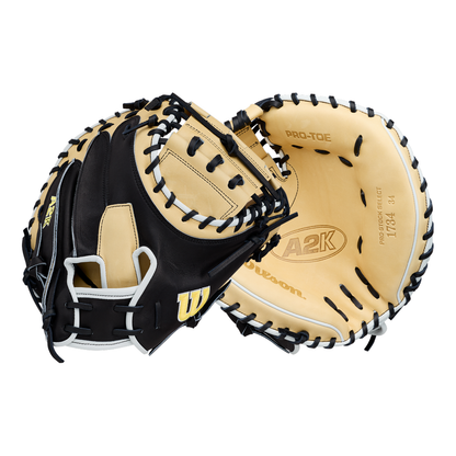 Two tan and black Wilson A2K 1734 34″ Baseball Catcher’s Mitts (WBG10701RT34), each with black laces, are shown from the front and back, displaying the Wilson brand and A2K logos on the palm. These mitts feature Double Palm Construction for enhanced stability and durability.