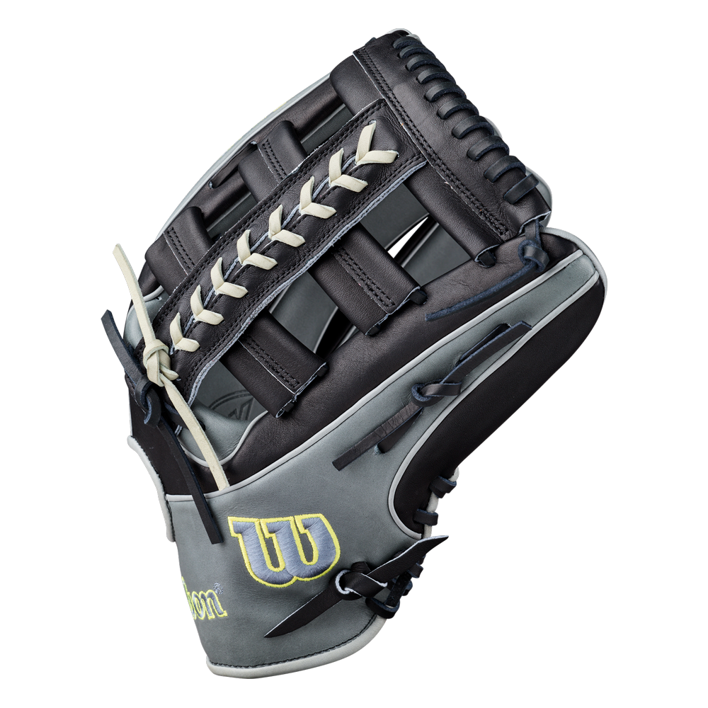 A Wilson A2K 1810 12.75″ Baseball Glove (WBG10802RT1275) in black and gray with white laces, highlighted by a yellow “W” logo on the side. Made from Pro Stock Select leather, this Wilson glove features an open web design and is shown palm-side out.