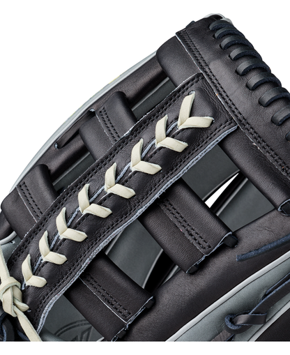 Close-up of a black Wilson A2K 1810 12.75″ Baseball Glove (WBG10802RT1275) crafted from Pro Stock Select leather with cream-colored laces, featuring intricate stitching and padding—an outstanding Wilson glove option for outfielders.