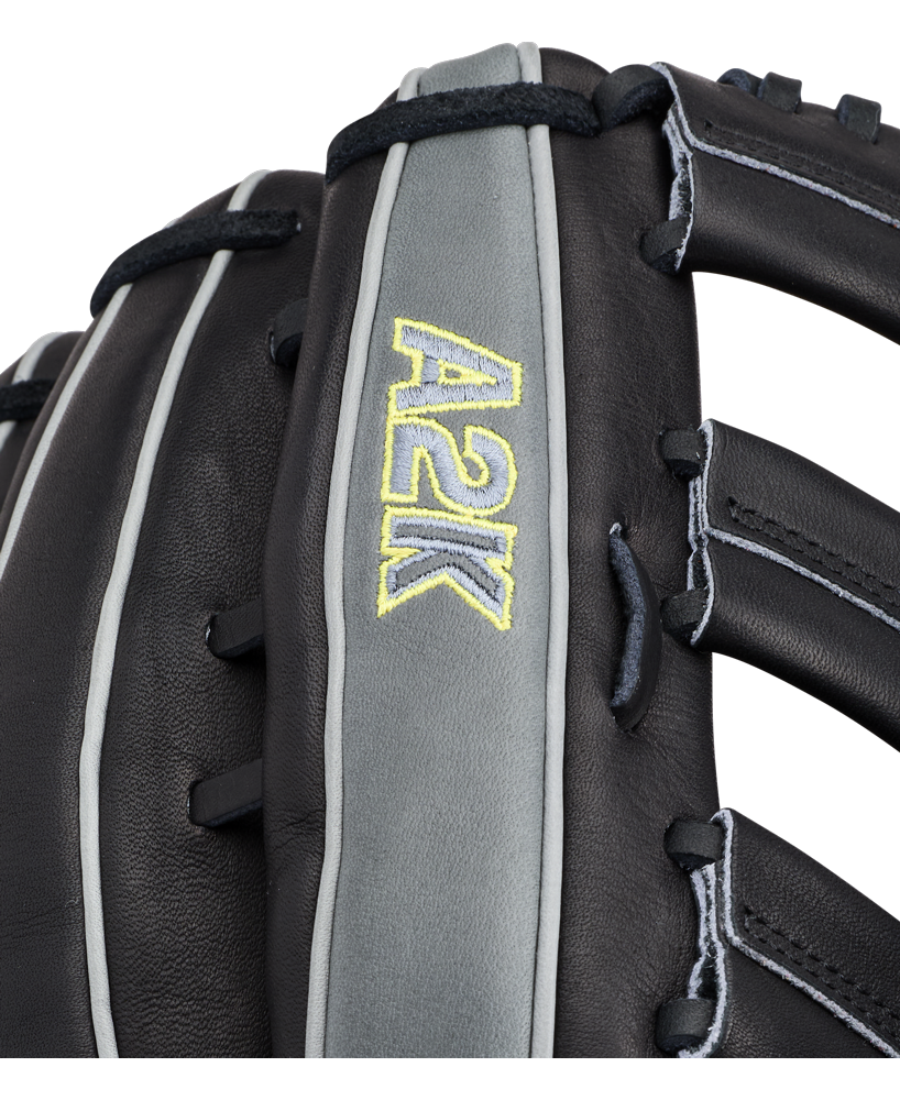 Close-up of a Wilson A2K 1810 12.75″ Baseball Glove (WBG10802RT1275) in black and gray, featuring “A2K” stitched in yellow on a gray strip, highlighting the detailed Pro Stock Select leather texture and intricate lacing.