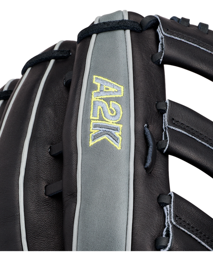 Close-up of a Wilson A2K 1810 12.75″ Baseball Glove (WBG10802RT1275) in black and gray, featuring “A2K” stitched in yellow on a gray strip, highlighting the detailed Pro Stock Select leather texture and intricate lacing.
