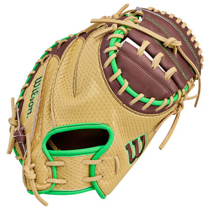 A Wilson A1000 CM33 DUBAI 33″ Baseball Catcher’s Mitt (WBG25101RT33) in tan and brown, featuring green stitching and accents, with an open pocket and detailed lacing.