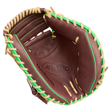 A Wilson A1000 CM33 DUBAI 33″ baseball catcher’s mitt (WBG25101RT33) by Wilson, shown open to display its brown exterior with tan and green laces and visible interior details.