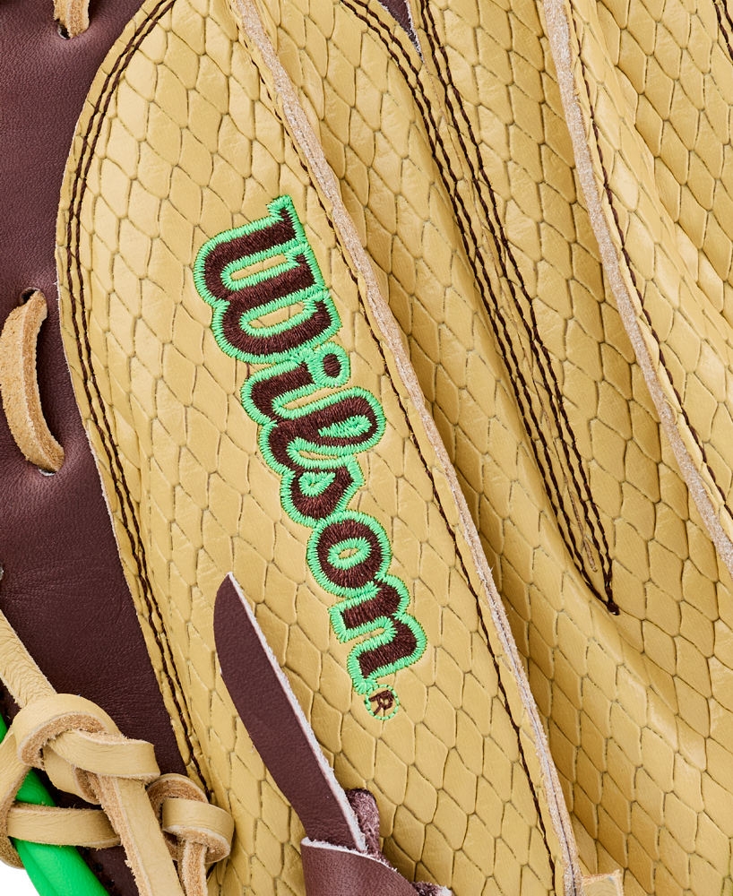 Close-up of a tan and brown Wilson A1000 CM33 DUBAI 33″ Baseball Catcher’s Mitt, highlighting the textured leather and green-embroidered Wilson logo.