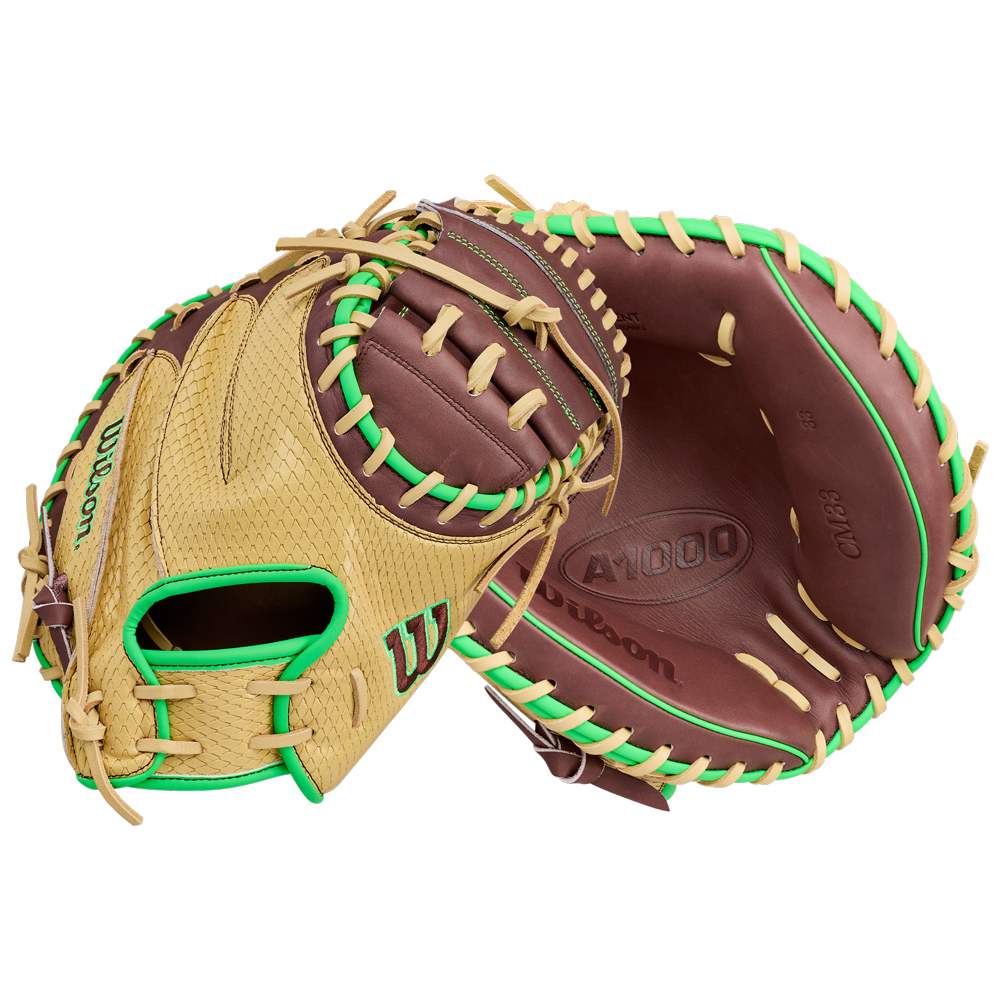 A Wilson A1000 CM33 DUBAI 33″ Baseball Catcher’s Mitt (WBG25101RT33) in tan and brown with green accents, shown from both the front and back, highlighting its webbing, stitching, and Wilson brand markings.