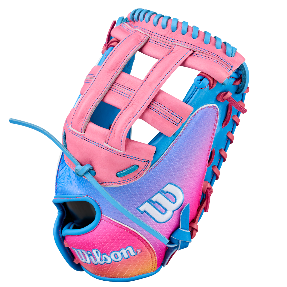 The Wilson A1000 FPCM33 MOMENTUM 33″ Fastpitch Catcher’s Mitt (WBG25301RT33) features a vibrant design in blue, pink, and purple hues with colorful lacing, a woven pocket, durable Full Grain leather construction, and prominent Wilson branding.