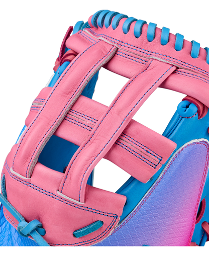 Close-up of a brightly colored Wilson A1000 FPCM33 MOMENTUM 33″ Fastpitch Catcher’s Mitt crafted from Full Grain leather, featuring pink and blue panels, detailed stitching, and an H-web design.