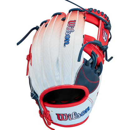 The Wilson A1000 1787 FREEBIRD 2.0 11.75″ Baseball Glove (WBG26501RT1175) by Wilson is an infield glove crafted with white, red, and blue full grain leather, featuring visible stitching and the iconic Wilson logo on the back for reliable performance on the diamond.
