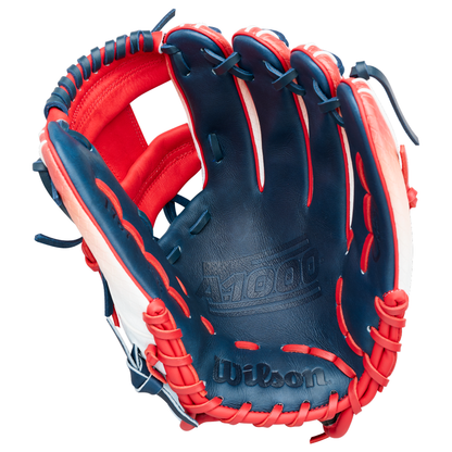 The Wilson A1000 1787 FREEBIRD 2.0 11.75″ Baseball Glove (WBG26501RT1175) features a striking blue, red, and white design with “A1000” inscribed inside the palm and intricate lacing around the edges; crafted from Full Grain leather, this Wilson glove is designed to deliver premium performance and lasting durability for infielders.