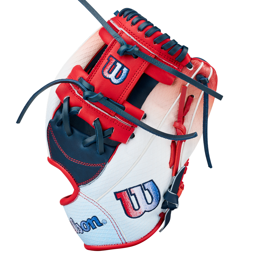 The Wilson A1000 1787 FREEBIRD 2.0 11.75″ Baseball Glove (WBG26501RT1175) by Wilson features a white, red, and navy blue design with red stitching, blue laces, and the iconic Wilson logo embroidered on its surface; it’s crafted from premium full grain leather for lasting durability.