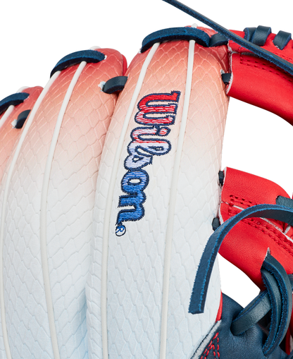 Close-up of the Wilson A1000 1787 FREEBIRD 2.0 11.75″ Baseball Glove (WBG26501RT1175) by Wilson, showcasing its white and red Full Grain leather construction with blue laces and visible stitching. The glove features an embroidered Wilson logo on the back.