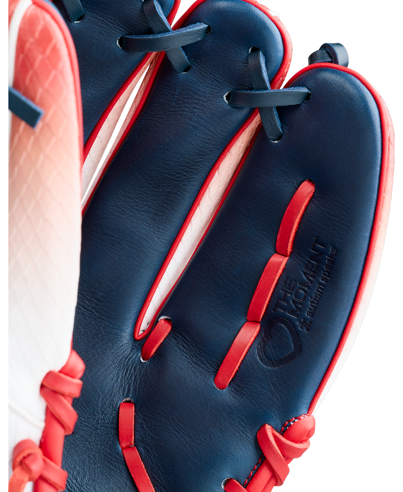Close-up of the Wilson A1000 1787 FREEBIRD 2.0 11.75″ Baseball Glove (WBG26501RT1175) by Wilson, featuring dark blue and red Full Grain leather, white stitching, and an embossed logo. Red laces accent both the fingers and the glove’s interior, emphasizing its durable construction.