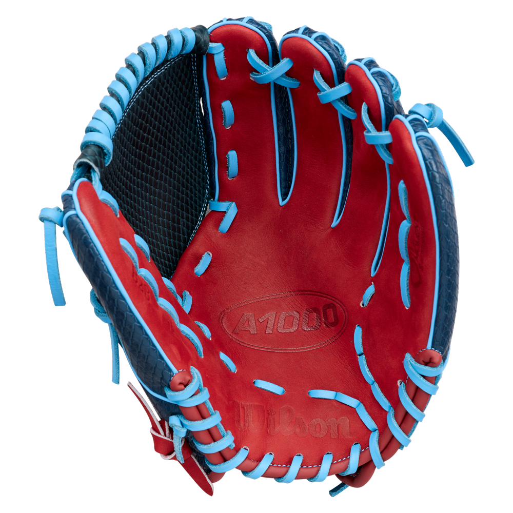 Showcasing the Wilson A1000 B23 GENO 12″ Baseball Glove (WBG26601RT12) in striking red and blue with blue laces and black webbing, this glove opens to reveal its embossed A1000 and Wilson branding on the palm—a top-quality choice from Wilson for any pitcher in need of a dependable glove.