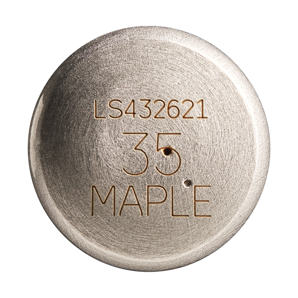 A round metallic object engraved with LS432621, 35, and MAPLE features a brushed texture and two small holes below the number, reminiscent of the classic craftsmanship of a Louisville Slugger Maple S345 Fungo 35″ Wood Training Bat.