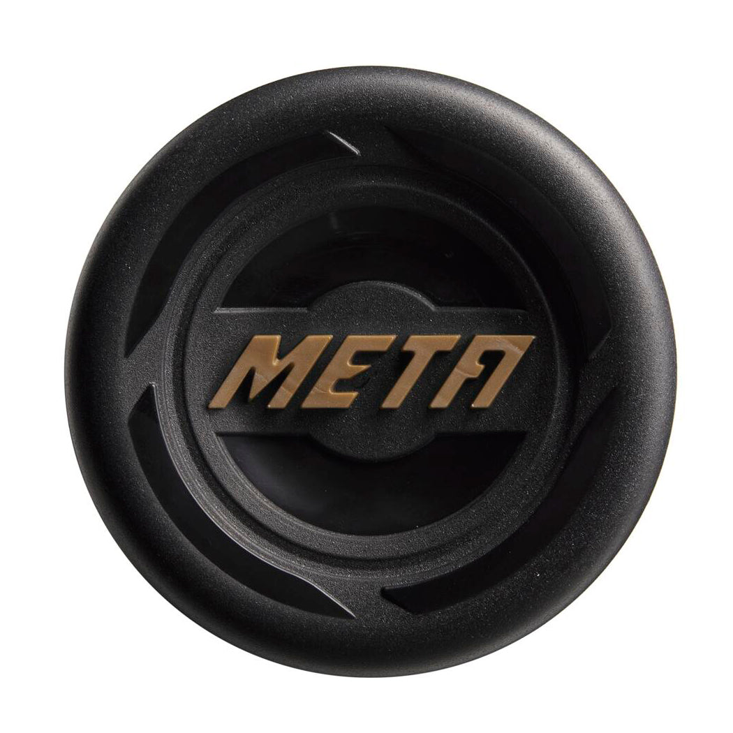 A black circular object featuring “META” in stylized gold letters, inspired by the Louisville Slugger Meta LTD (-8) USSSA Baseball Bat (WBL2822010), is displayed against a plain white background.