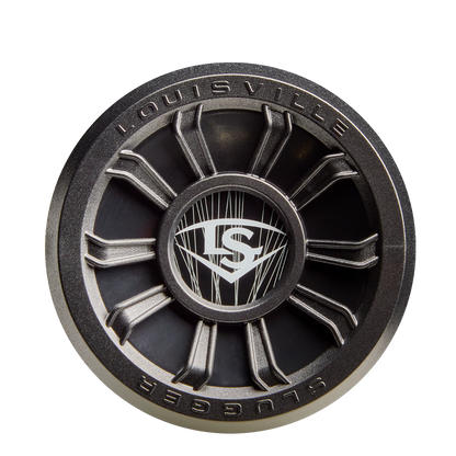 A close-up of the 2026 Louisville Slugger Select PWR (-10) USA Baseball Bat end cap highlights its round, metallic design with a central LS logo and spoke-like elements engineered for added vibration control.