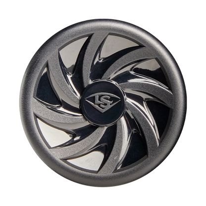 A metallic, circular object with a black center engraved with the Louisville Slugger logo. Its outer edge mirrors the swirling, reflective blade design of the 2026 Louisville Slugger Atlas (-12.5) T-Ball Bat against a white background.