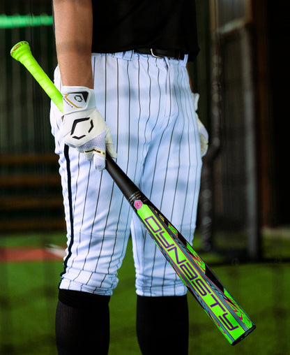 A baseball player in white pinstripe pants and gloves holds a neon green and black 2027 Louisville Slugger Dynasty (-3) BBCOR Baseball Bat (WBL4250010) while standing on turf.