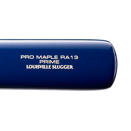 Close-up of a blue Louisville Slugger Pro Prime RA13 USA Maple Wood Baseball Bat (WBL4296010), with white text on the barrel, featuring Seamless Decals and a Professional Series Finish for a premium look and feel.
