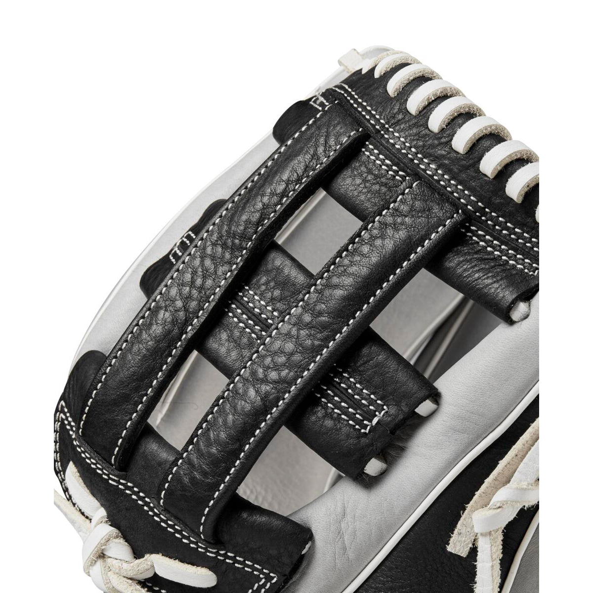 Close-up of the Wilson A1000 IF12 12" Fastpitch Glove by Wilson, showcasing its black and white leather design, detailed stitching, and distinctive webbing between the thumb and fingers.
