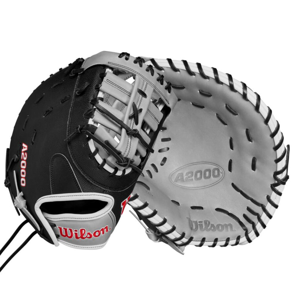 A Wilson A2000 1620SS 12.5" SuperSkin Fastpitch First Base Mitt is shown in black and gray, displaying palm and back sides. The mitt is crafted with Pro Stock leather, features visible laces, the Wilson logo, and red A2000 text.